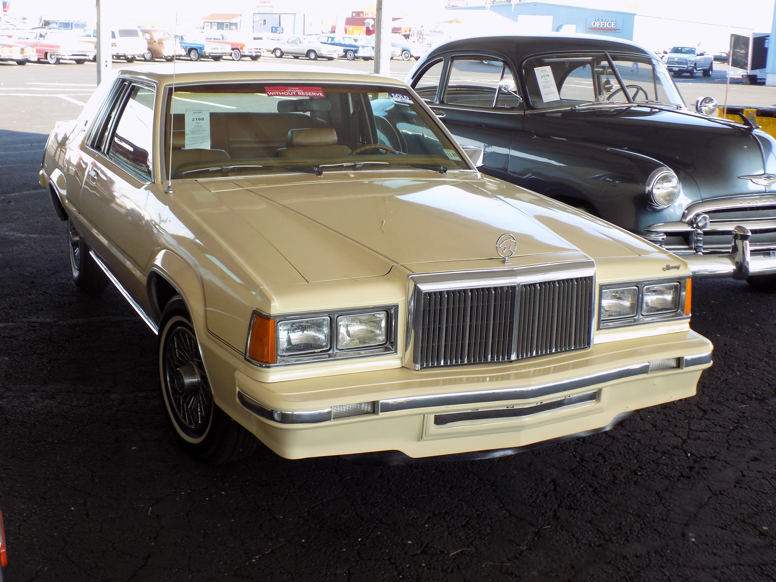 The collector market extends beyond headline supercars: a 1980 Mercury Cougar XR-7 at the Auburn Spring auction in Indiana, May 2017. Historical illustration, not a Monterey 2026 lot. Photo: Greg Gjerdingen / Wikimedia Commons, CC BY 2.0 (https://creativecommons.org/licenses/by/2.0/). Source: https://commons.wikimedia.org/wiki/File:1980_Mercury_Cougar_XR-7_(33944261074).jpg . Resized; original composition retained.